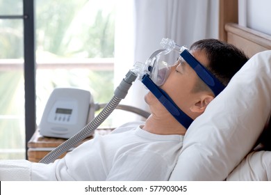 Healthy Senior Man Wearing Cpap Mask Sleeping Smoothly On His Back Without Snoring During Day Break,side View With Backlit.Obstructive Sleep Apnea Therapy.
