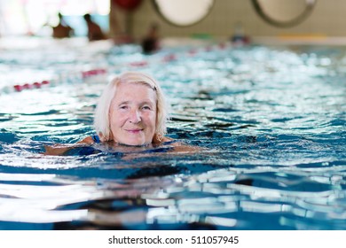 Healthy Senior Woman Swimming In The Pool. Happy Pensioner Enjoying Sportive Lifestyle. Active Retirement Concept.