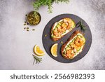 Healthy shrimp sandwiches for breakfast, snack, appetizers Toast with grilled prawns and whole grain bread with cream cheese and arugula on a light background, top view