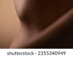 Healthy, skin and body of woman closeup for beauty, cosmetics or wellness in brown background in studio. Skincare, texture and glow from dermatology, self care or natural treatment in salon or spa