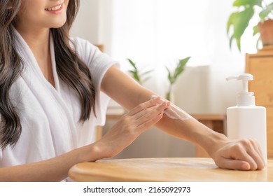 Healthy skin care, beauty asian young woman in bathrobe, towel after shower bath at home, hand in applying, putting moisturizer on her arm. Skin body cream moisturizing lotion, routine in the morning - Shutterstock ID 2165092973