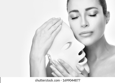 Healthy Skin Woman With Led Mask. Led Skin Rejuvenation Therapy Mask. Monochrome Beauty Portrait On White