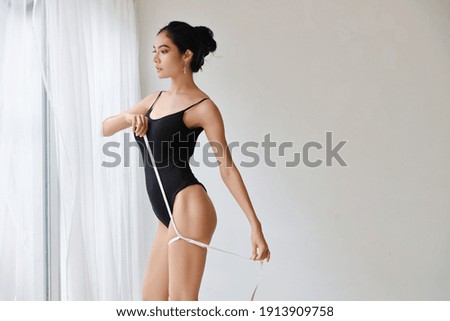 healthy and slim woman taking measurements of her body