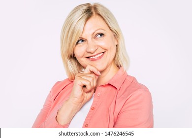 Healthy smile. Close up portrait of happy smiling and beautiful blonde senior woman isolated in studio and posing with smile on camera