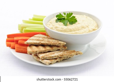 Healthy Snack Of Hummus Dip With Pita Bread Slices And Vegetables