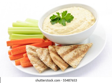 Healthy Snack Of Hummus Dip With Pita Bread Slices And Vegetables