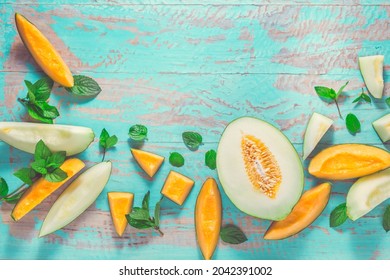 Healthy snack - Piel de sapo melon and cantaloupe with fresh mint on cyan wooden table