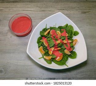 A Healthy Spinach Salad With Mandarin Oranges And Raspberry Vinaigrette Dressing.