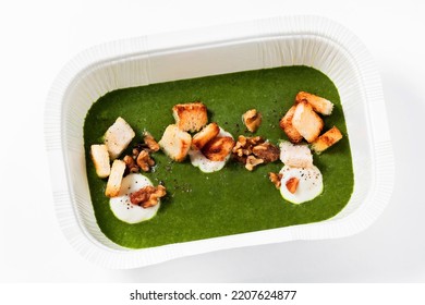 Healthy Spinach Soup With Croutons And Cheese Sauce. Healthy Food In A Plastic Takeout Container