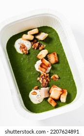 Healthy Spinach Soup With Croutons And Cheese Sauce. Healthy Food In A Plastic Takeout Container