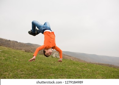 healthy sport little caucasian boy jumping flying upside down in air outdoors mountain training copyspace - Shutterstock ID 1279184989