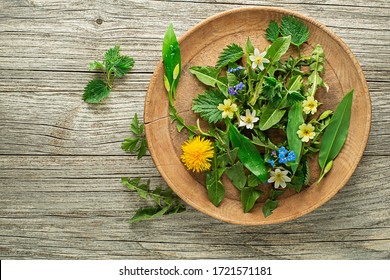 Healthy Spring Plants Food Ingredients. Dandelion, Wild Garlic, Flowers And Nettle On Wooden Background