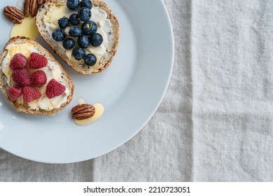 Healthy Summer Breakfast, Sandwiches With Cheese Spread, Blueberry, Raspberry Fruits, Honey And Pecan On White Plate, Top View