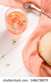 Healthy summer drink grapefruit lemonade with thyme in glasses with ice on a wooden surface. - Shutterstock ID 1486738079