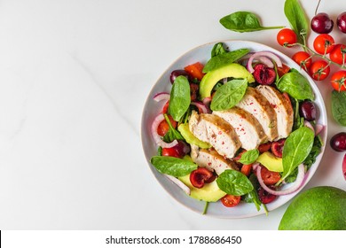 Healthy Summer Salad With Grilled Chicken Breast, Avocado, Spinach, Cherry Berries And Tomato On White Background. Healthy Diet Food. Top View With Copy Space