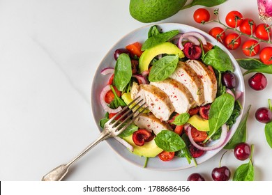 Healthy Summer Salad With Grilled Chicken Breast, Avocado, Spinach, Cherry Berries And Tomato In A Plate With Fork On White Background. Healthy Diet Food. Top View