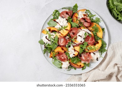 Healthy summer salad with peach, burrata, arugula and jamon. Healthy eating. - Powered by Shutterstock