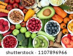 Healthy super food concept with vegetables, fruit, herbs, spice and nuts. Food very high in antioxidants, anthocyanins, omega 3, minerals and vitamins.