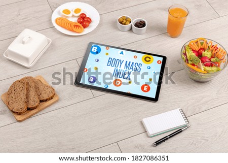 Healthy Tablet Pc compostion with BODY MASS INDEX inscription, weight loss concept