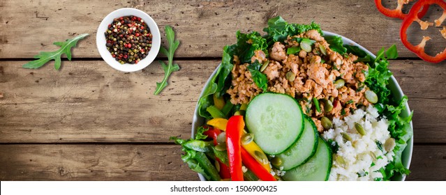 Healthy Taco Bowl. Ground Turkey Meat, Cauliflower Rice, Paprika And Cucumbers On Wooden Table. Copy Space. Banner, Cover. Flat Lay, Top View.