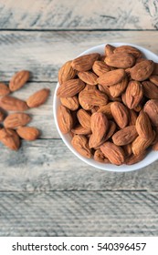 Healthy, Tasty And Nutritious Nuts Which Help To Build Strong Bones And Teeth. Almonds On Wooden Table. Vertical Photo. Top View. 