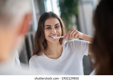 Healthy Teeth. A Woman Brushing Her Teeth In The Morning