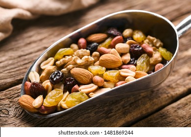 Healthy Trail Mix Snack Made Of Nuts (walnut, Almond, Peanut) And Dried Fruits (raisin, Sultana) On Iron Scoop (Selective Focus, Focus One Third Into The Scoop)