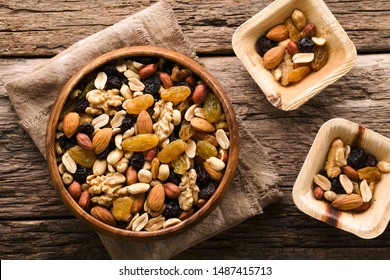 Healthy Trail Mix Snack Made Of Nuts (walnut, Almond, Peanut) And Dried Fruits (raisin, Sultana) In Wooden Bowl, Photographed Overhead (Selective Focus, Focus On The Trail Mix In The Big Bowl)