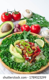 Healthy Trendy Vegan Burrito Bowl With White Rice, Spicy Tomato Mushroom Mix, Green Arugula, Lemon And Sliced Avocado. Topped With Red And Green Chili Peppers And Scallions