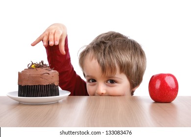 Healthy or unhealthy eating little boy choosing between a cake or an apple