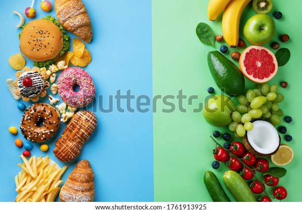 Healthy and unhealthy\
food background from fruits and vegetables vs fast food, sweets and\
pastry top view. Diet and detox against calorie and overweight\
lifestyle concept.