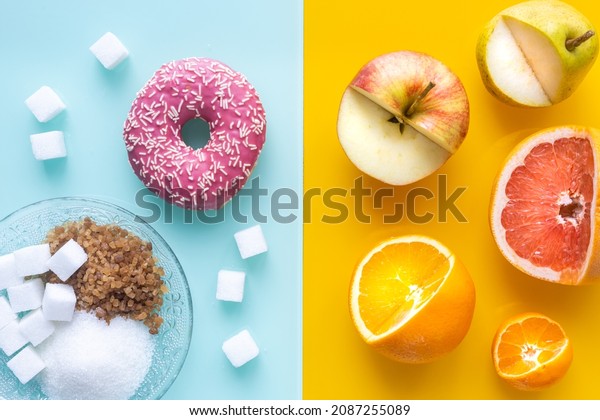 Healthy and unhealthy sugar, Yellow, pastel blue\
background, Juicy fruit in front of a sweet donut and various types\
of processed sugars, gucose and fructose versus sucrose and\
calulose starch 
