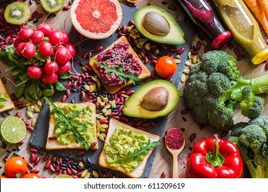 Healthy vegan food. Fresh vegetables on wooden background. Detox diet. Different colorful fresh juices. - Shutterstock ID 611209619