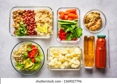 Healthy Vegan Food In Glass Containers, Top View. Rice, Beans, Vegetables, Hummus And Juice For Take-away Lunch