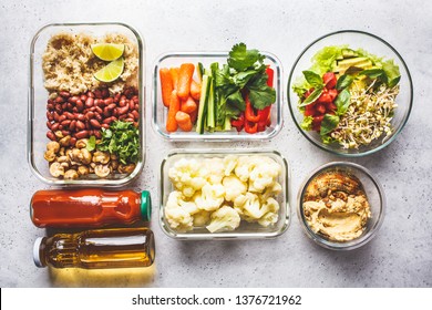 Healthy Vegan Food In Glass Containers, Top View. Rice, Beans, Vegetables, Hummus And Juice For Take-away Lunch