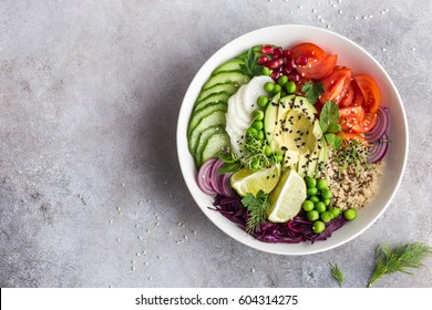 healthy vegan lunch bowl. Avocado, quinoa, tomato, cucumber, red cabbage, green peas and radish  vegetables salad. Top view - Shutterstock ID 604314275