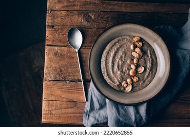 Healthy Vegan Mushroom Soup With Crackers, Made From Button Mushrooms And Coconut Cream, Dark Rustic Background