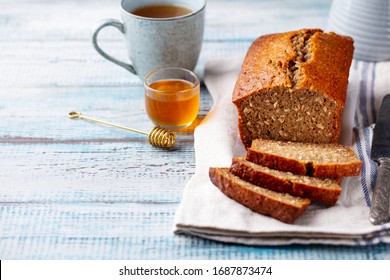 Healthy vegan oat and banana loaf bread, cake. Wooden background. Copy space.
