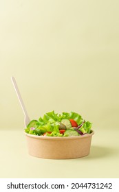 Healthy Vegetable Salad In Recyclable Cardboard Container. Food Delivery, Healthy Food Menu For Home Or Office Concept. Green Background, Side View