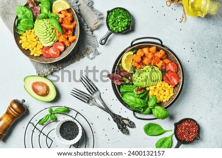 Healthy vegetarian breakfast: pumpkin, avocado, corn and tomatoes, clean eating, vegan food concept. Top view