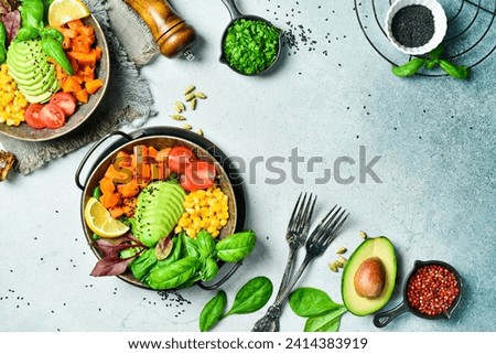 Healthy vegetarian breakfast: pumpkin, avocado, corn and tomatoes, clean eating, vegan food concept. Top view