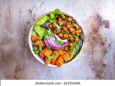Healthy vegetarian buddha bowl salad with vegetables, sweet potato, chickpea, salad leaves