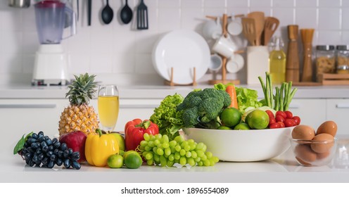 healthy and vegetarian foods background and banner of arrangement of fruits, vetgetables and eggs on white table in kitchen