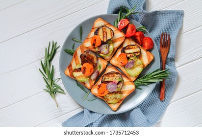 Healthy vegetarian grilled sandwiches with vegetables and rosemary for breakfast on white wooden background with copy space
