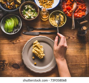 Healthy Vegetarian Salad Bar. Women Female Hand With Spoon Puts Food On A Plate, Top View. Clean Eating Or Diet Food Concept