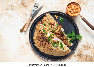 Healthy Vegetarian Tortilla Or Pita Bread With Chickpeas, Vegetables And Herbs Served With Homemade Hummus In Vintage Dishes. Healthy Eating Concept. Light Background. Top View. Copy Space