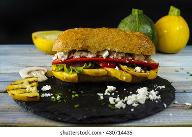 Healthy Vegetarian Veggie Sandwich With  Grilled Yellow Squash Zuccini, Mushrooms, Paprika, Salad, Feta Cheese On Blue Table Top