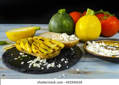 Healthy Vegetarian Veggie Sandwich With  Grilled Yellow Squash Zucchini, Mushrooms, Paprika, Salad, Feta Cheese On Blue Table Top