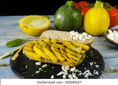 Healthy Vegetarian Veggie Sandwich With  Grilled Yellow Squash Zucchini, Mushrooms, Paprika, Salad, Feta Cheese On Blue Table Top