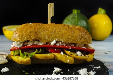 Healthy Vegetarian Veggie Sandwich With  Grilled Yellow Squash Zuccihi, Mushrooms, Paprika, Salad, Feta Cheese On Blue Table Top